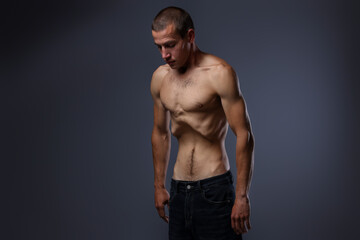 Man suffering from anorexia on grey background