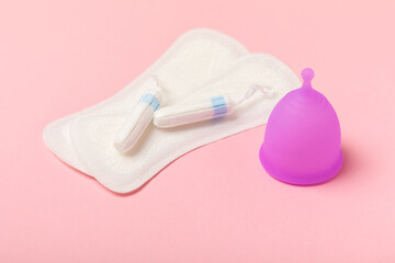 Menstrual cup on a bright background. Sanitary napkins, tampons and menstrual cup.Concept of...