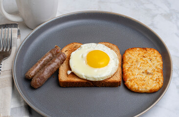 fried egg on toast  with breakfast links