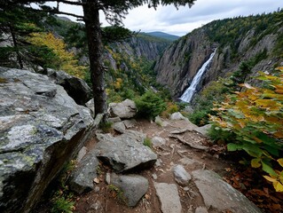 Waterfall descends into cliffside autumn valley
