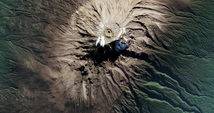 Top view on Kilimanjaro volcano surrounded by jungles. Camera is moving forward and right. Animation based on image by NASA