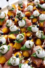 Peaches with mozzarella, prosciutto and basil