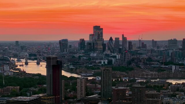 Panoramic aerial view of the skyline of London, England, during a colourful sumer sunset with River Thames, Tower Bridge and city skyscrapers