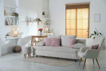 Comfortable sofa with cushions in room. Interior design
