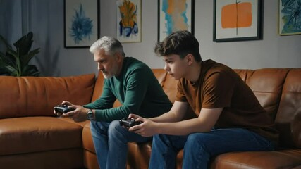 Father and son playing video games. - Powered by Adobe
