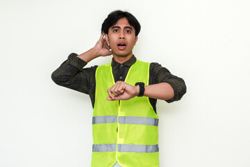 Portrait of a stressed Asian construction worker looking at his watch with a panicked expression,...