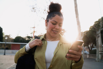 Young Hispanic woman enjoys ultra-fast 5G internet on her smartphone, managing banking applications and transactions. Digital finance and seamless connectivity shape modern mobile experiences