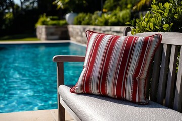 Striped red cushion on the bench by the pool.