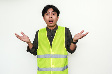 Young Asian engineer looks confused, hand raised in shock. Isolated portrait capturing a moment of...