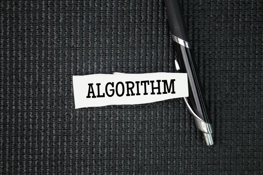Pen and torn paper with the word algorithm. a process or set of rules to be followed in calculations or other problem-solving operations, especially by a computer.