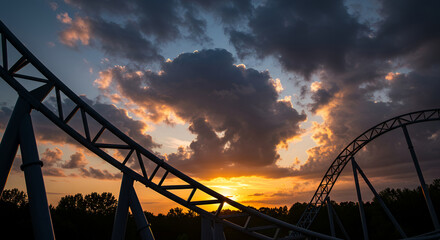 Roller coaster silhouette set against sunset metal tracks form geometric shapes