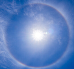 A beautiful rare atmospheric phenomenon of halo in the blue day sky.A halo is an optical...