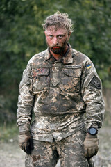 The face of a Ukrainian soldier in blood. A soldier after being wounded. A difficult scene...
