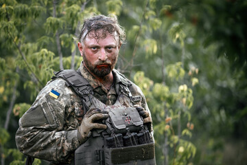 The face of a Ukrainian soldier in blood. A soldier after being wounded. A difficult scene...
