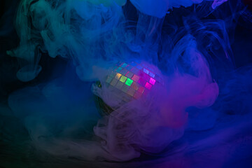 Image portrays a lively nightclub ambiance with a colorful disco ball and blue smoke, ideal for...