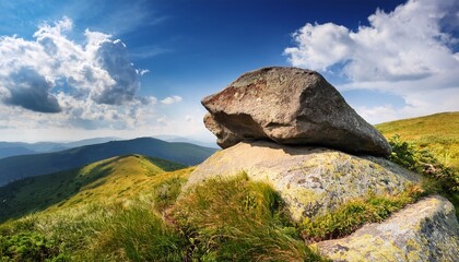 boulder on a hill under blue sky with clouds in summer huge sandstone among the grass journey to beautiful highland of ukraine
