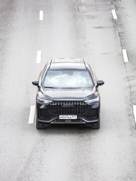 Chery Tiggo 9 car model on the highway in motion, aerial frontal view