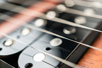 A close-up shot showcases a polished, beautifully crafted guitar in soft light The wood grain adds...