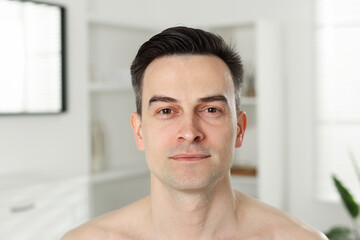 Portrait of handsome man after shaving at home