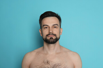 Handsome man before shaving on light blue background