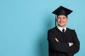 Happy student after graduation on light blue background. Space for text