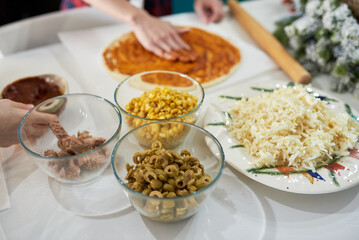 making homemade pizza at home in the kitchen