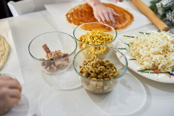 making homemade pizza at home in the kitchen