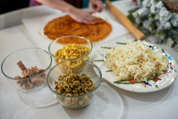 making homemade pizza at home in the kitchen