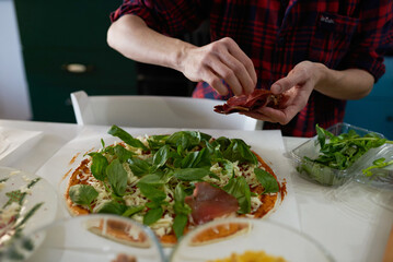 making homemade pizza at home in the kitchen
