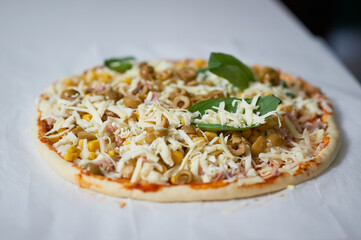 making homemade pizza at home in the kitchen