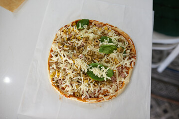 making homemade pizza at home in the kitchen