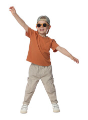Happy little boy with sunglasses dancing on white background