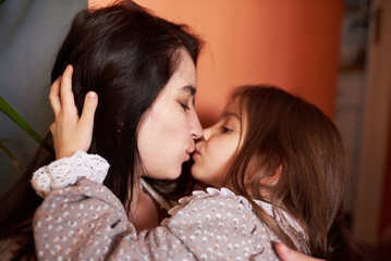 portrait of mother with daughter at home, cute and cozy photo