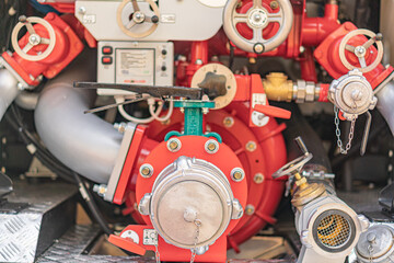 Firetruck or rescue vehicle with red engine compartment, green valvetap, hydraulic pump, metallic...