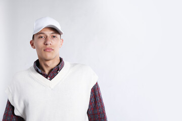 Young man in stylish baseball hat on light grey background, space for text