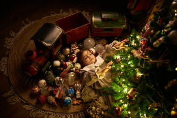 cute girl at cozy home under decorated christmas tree