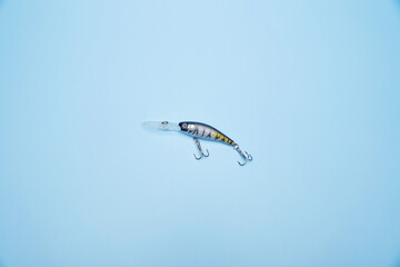 Spoon bait wobbler jig isolated on the bright blue fond background