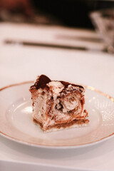 Sweet delicious cake piece with butter and chocolate cream on the plate