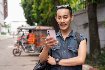 Nonbinary genderfluid young Thai gay man tourist in Thailand