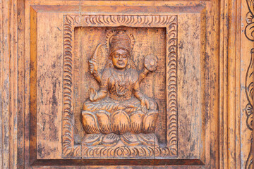 Intricate Wood Carving of Hindu Four-Armed Goddess Seated on Lotus with Weapons and Blessing...