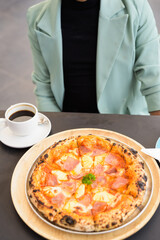 Businessman ready to eat Hawaiian pizza with pineapple and ham