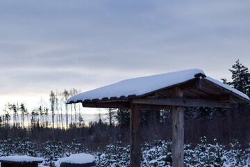 Snowy Wooden Shelter in a Winter Landscape
