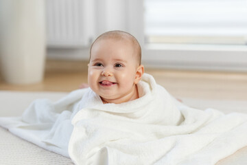 Happy Baby Wrapped in White Towel After Bath. Copy space
