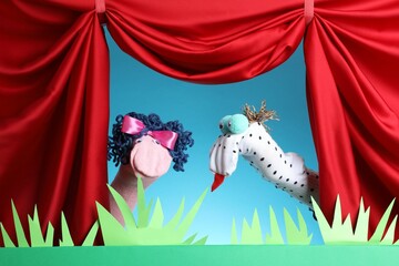 Naklejka premium Creative puppet show on stage with decorations and red curtains
