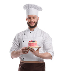 Happy confectioner in uniform holding delicious cake with berries on white background