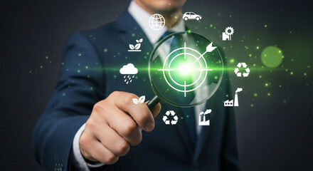 A businessman holding a magnifying glass over a target with environmental icons around it in green light