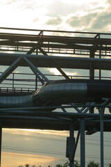 There is an impressive bridge that has a multitude of pipes extending over its structure, creating a unique appearance