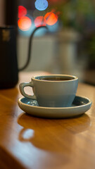 Close up of hot coffee or tea wooden table with bokeh background	