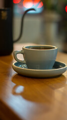 Cup of hot coffee on wooden table with bokeh background