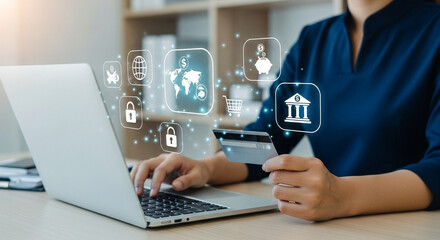Woman using laptop for online banking with credit card and digital financial icons floating above it